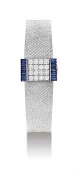 PATEK PHILIPPE. A LADY ’ S FINE AND ELEGANT 18K WHITE GOLD, DIAMOND AND SAPPHIRE-SET RECTANGULAR BRACELET WATCH WITH CONCEALED DIAL