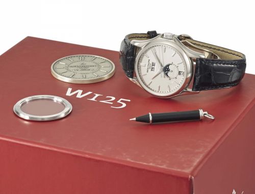 Patek Philippe. A very fine and rare 18K white gold annual calendar limited edition automatic wristwatch with sweep centre seconds, 24 hours indication, moon phases, original certificate, second case back and box, made for the 125th anniversary for Wempe