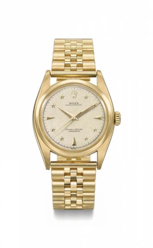 Rolex. A highly attractive and extremely rare 18K gold automatic sweep centre seconds wristwatch with luminous honeycomb star dial, gilt movement and bracelet