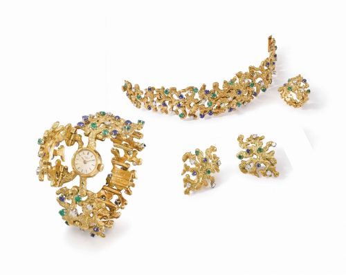 Patek Philippe. An extremely fine, elegant and possibly unique 18K gold, platinum, diamond, sapphire and emerald-set suite comprising a bracelet watch with concealed dial, matching ring and pair of earrings