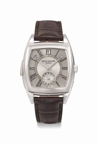Patek Philippe. An extremely fine and rare platinum tonneau-shaped automatic “cathedral” minute repeating annual calendar wristwatch with two-tone silvered dial and elongated Roman numerals, original sales tag, second case back, setting pin and boxb/b