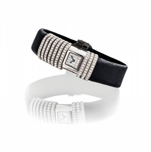 CARTIER. A LADY'S 18K WHITE GOLD, TITANIUM AND DIAMOND-SET RECTANGULAR WRISTWATCH WITH CONCEALED DIAL