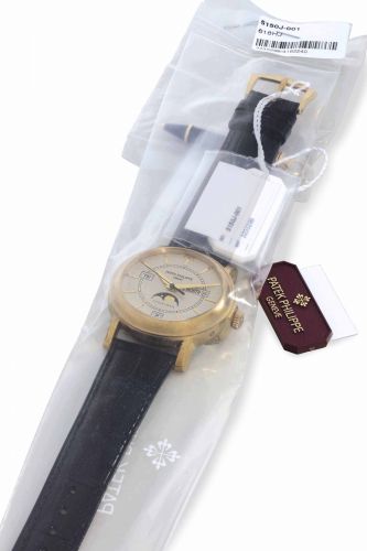 Patek Philippe. A Very Rare 18k Gold Limited Edition Automatic Annual Calendar Wristwatch with Moon Phases and Center Seconds