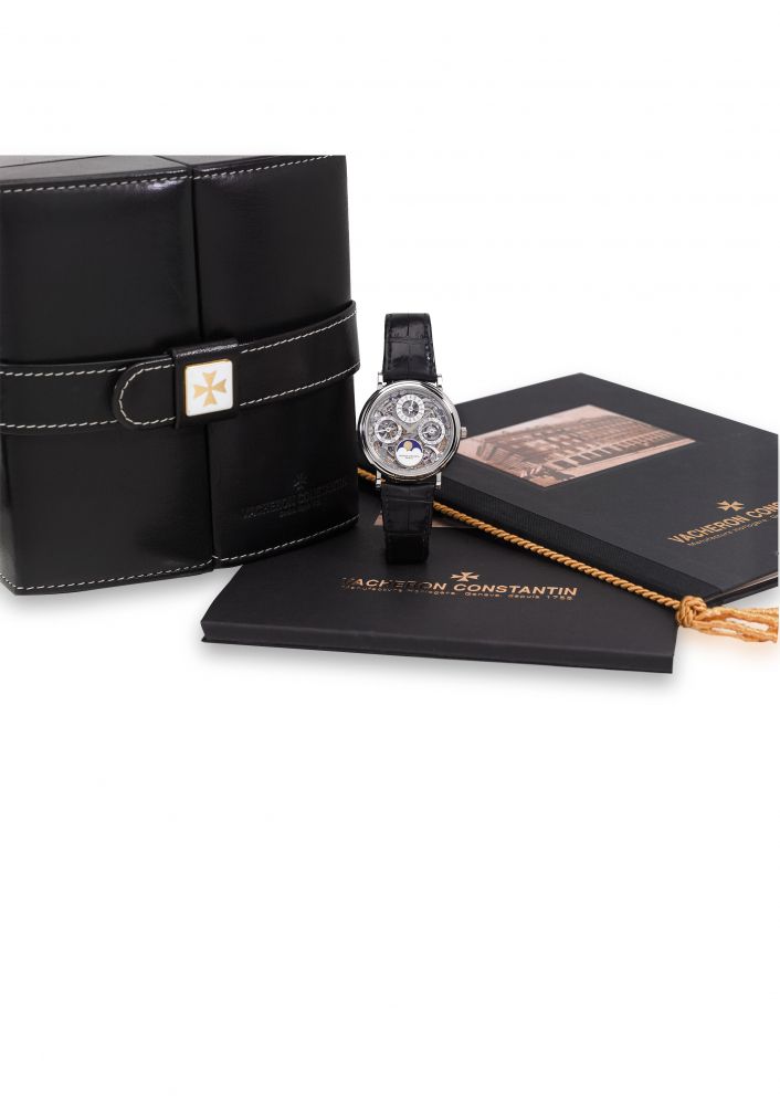 VACHERON CONSTANTIN. A FINE AND RARE PLATINUM PERPETUAL CALENDAR SKELETONISED WRISTWATCH WITH MOON PHASES, ORIGINAL CERTIFICATE AND BOX