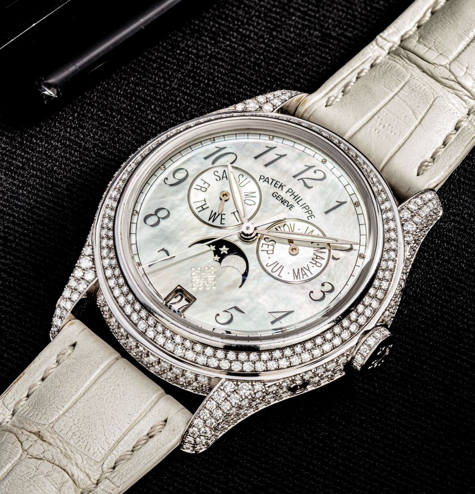 PATEK PHILIPPE. A LADY’S FINE AND ATTRACTIVE 18K WHITE GOLD AND DIAMOND-SET AUTOMATIC ANNUAL CALENDAR WRISTWATCH WITH SWEEP CENTRE SECONDS, MOON PHASES AND MOTHER-OF-PEARL DIAL