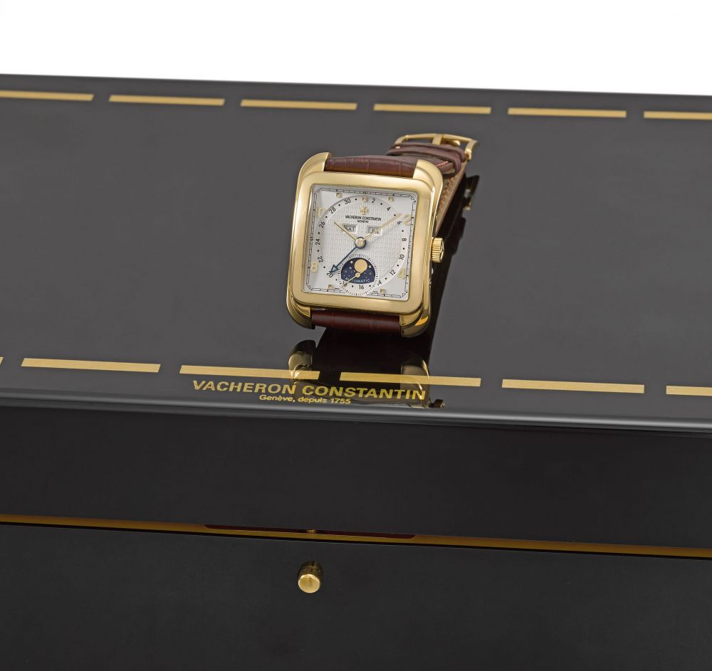 Vacheron Constantin. A large and attractive 18K gold cushion-shaped automatic triple calendar wristwatch with moon phases and box