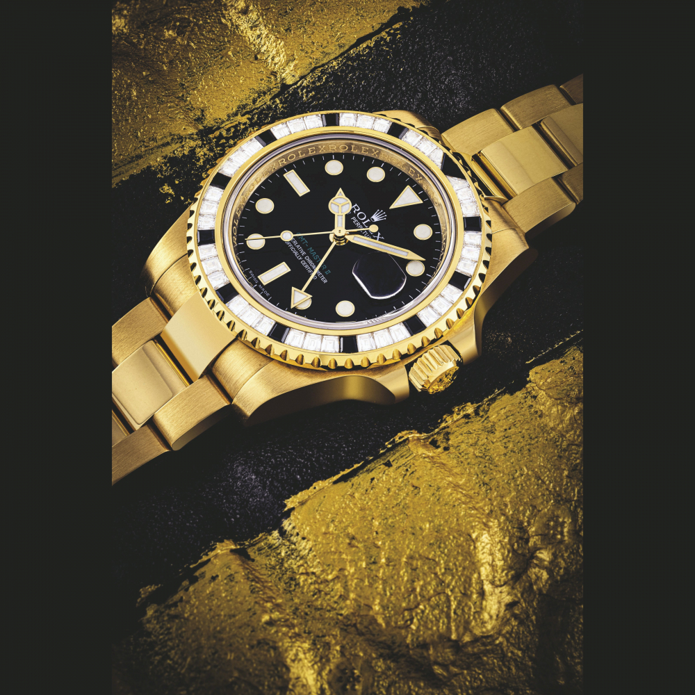ROLEX. AN 18K GOLD, DIAMOND AND BLACK SAPPHIRE-SET AUTOMATIC DUAL TIME WRISTWATCH WITH SWEEP CENTRE SECONDS, DATE AND BRACELET