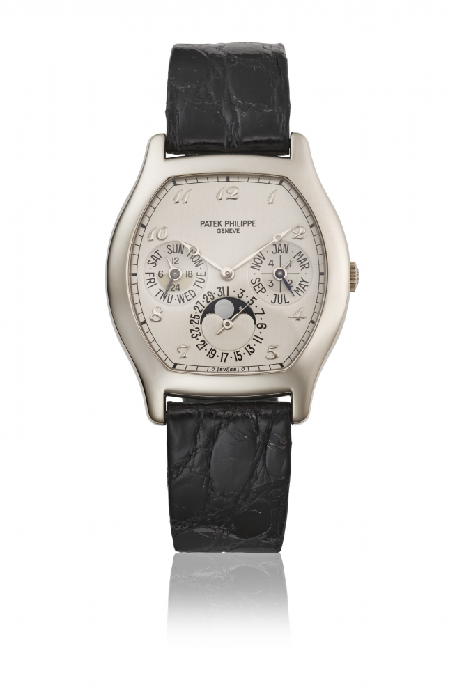PATEK PHILIPPE. A RARE 18K WHITE GOLD TONNEAU-SHAPED AUTOMATIC PERPETUAL CALENDAR WRISTWATCH WITH MOON PHASES, 24 HOUR AND LEAP YEAR INDICATION, ADDITIONAL CASE BACK, CERTIFICATE OF ORIGIN AND BOX