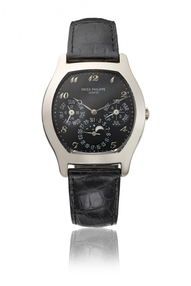 PATEK PHILIPPE. A VERY RARE AND ATTRACTIVE 18K WHITE GOLD TONNEAU-SHAPED AUTOMATIC PERPETUAL CALENDAR WRISTWATCH WITH MOON PHASES, ADDITIONAL CASE BACK AND BOX
