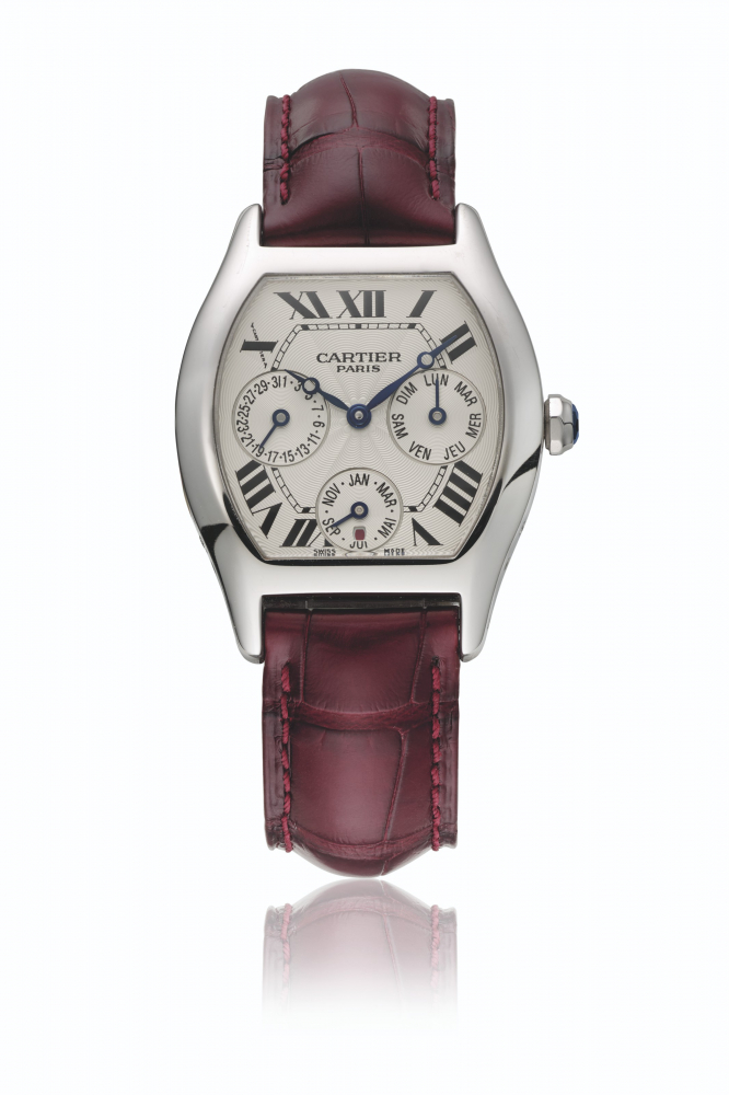 CARTIER. A RARE 18K WHITE GOLD TONNEAU-SHAPED AUTOMATIC PERPETUAL CALENDAR WRISTWATCH WITH LEAP YEAR INDICATION