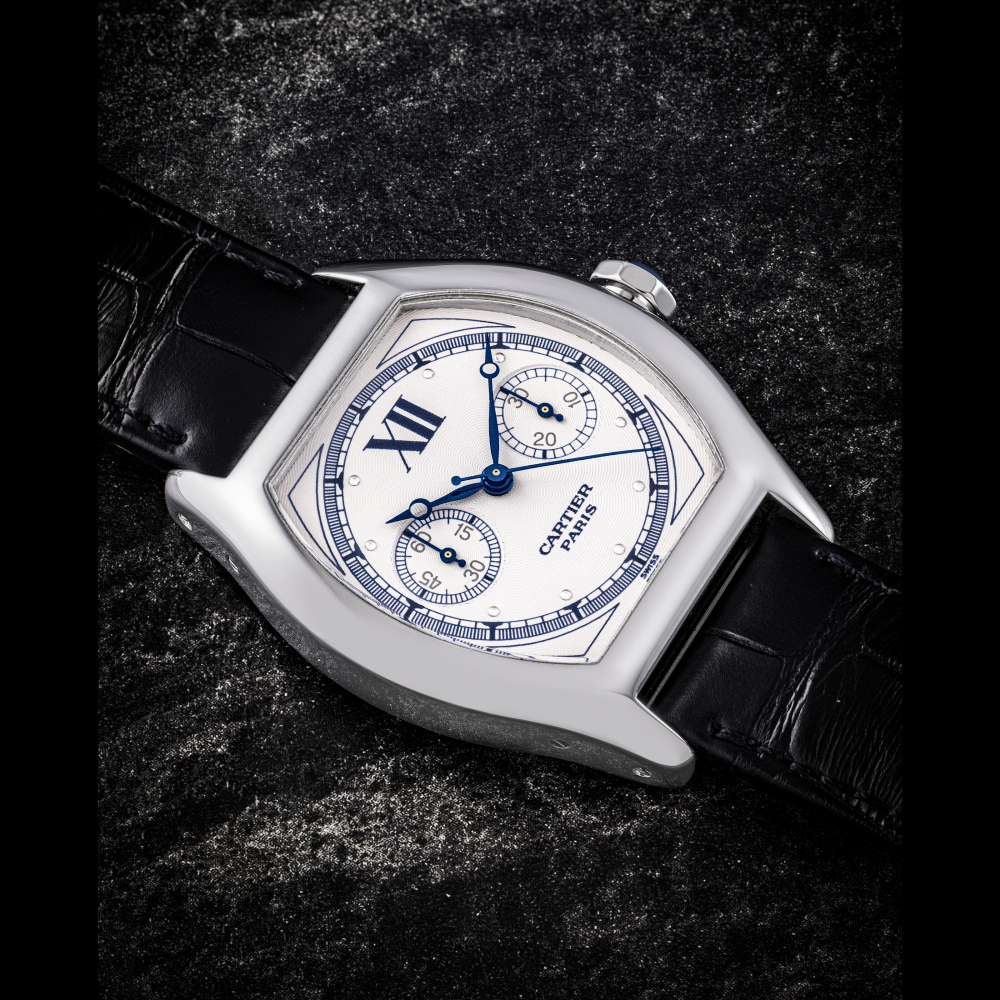 CARTIER. AN 18K WHITE GOLD TONNEAU SHAPED SINGLE BUTTON CHRONOGRAPH WRISTWATCH