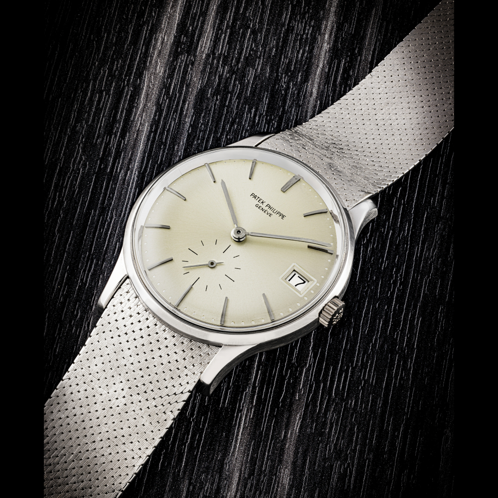 PATEK PHILIPPE. AN 18K WHITE GOLD AUTOMATIC WRISTWATCH WITH DATE AND BRACELET