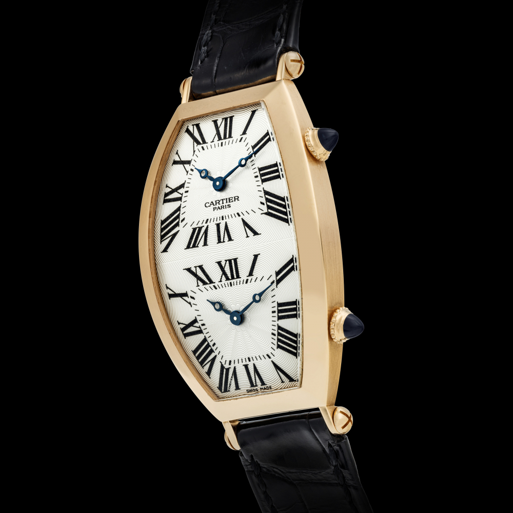 CARTIER. AN 18K PINK GOLD TONNEAU-SHAPED DUAL TIME WRISTWATCH