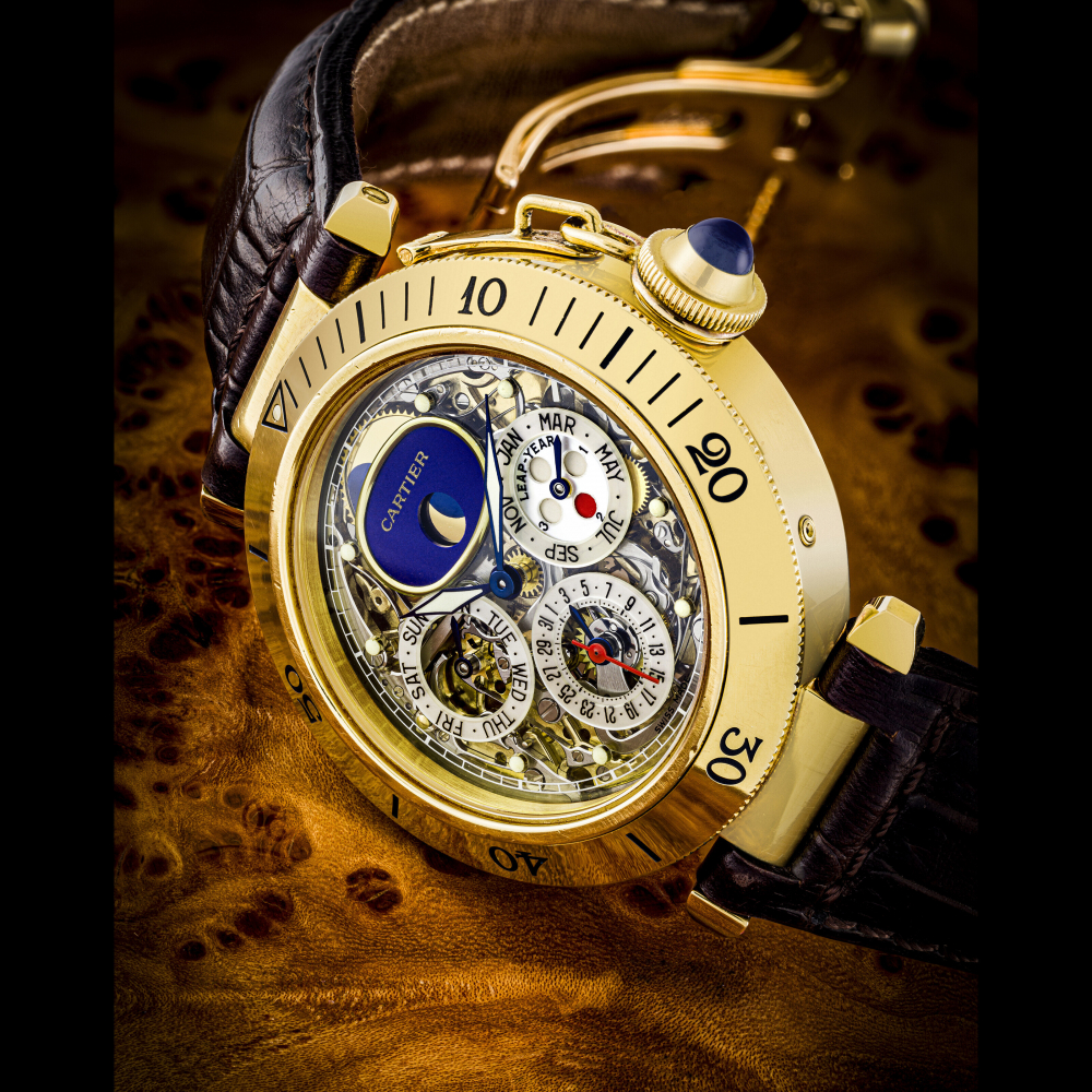 CARTIER. A RARE 18K GOLD AUTOMATIC SEMI-SKELETONISED TOURBILLON PERPETUAL CALENDAR WRISTWATCH WITH MOON PHASES, LEAP YEAR INDICATION AND MOTHER-OF-PEARL SUB-DIALS