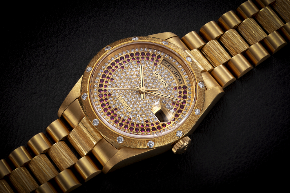 ROLEX, DAY-DATE REF. 18308, A GOLD AND DIAMOND-SET WRISTWATCH WITH PAVED DIAMOND AND RUBY DIAL - CASE