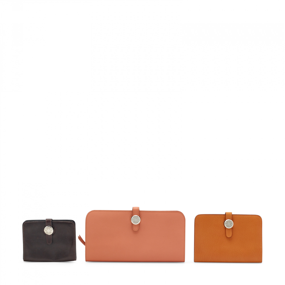 A SET OF THREE: A FLAMINGO EVERCOLOR LEATER DOGON VERSO WALLET WITH PALLADIUM HARDWARE, AN ORANGE TOGO LEATHER SMALL DOGON WALLET, AN ÉBÈNE EVERCALF LEATHER DOGON PM COIN PURSE - HERMÈS