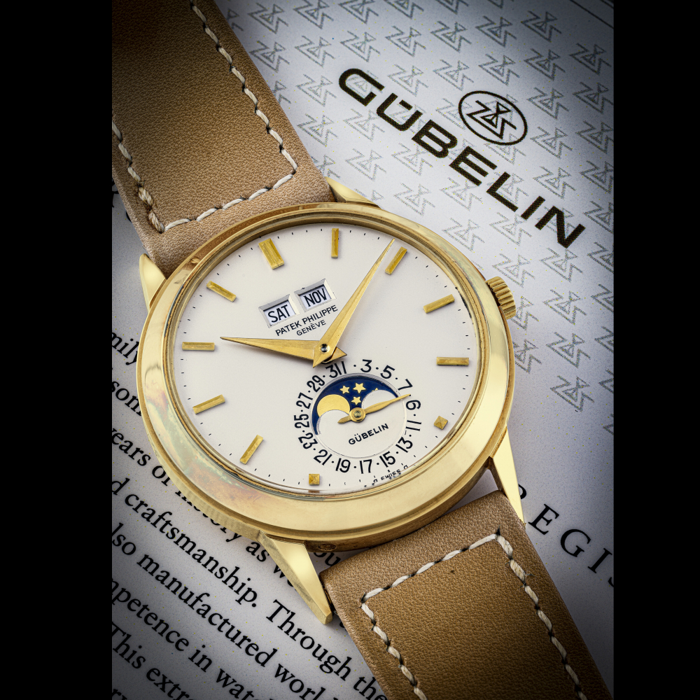 PATEK PHILIPPE. A VERY RARE AND WELL PRESERVED 18K GOLD AUTOMATIC PERPETUAL CALENDAR WRISTWATCH WITH MOON PHASES, RETAILED BY GÜBELIN