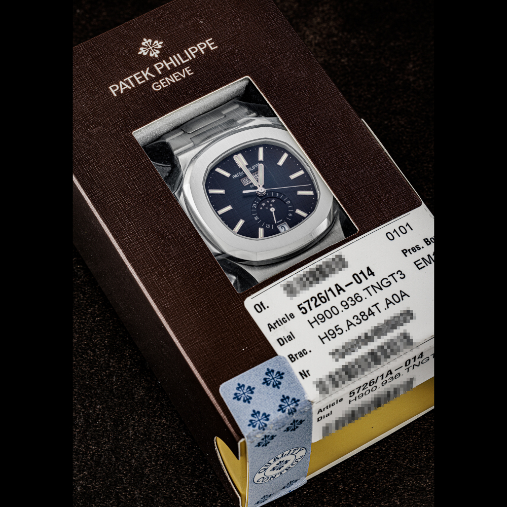 PATEK PHILIPPE. A STAINLESS STEEL AUTOMATIC ANNUAL CALENDAR WRISTWATCH WITH SWEEP CENTRE SECONDS, MOON PHASES, 24 HOUR INDICATION AND BRACELET, DOUBLE SEALED