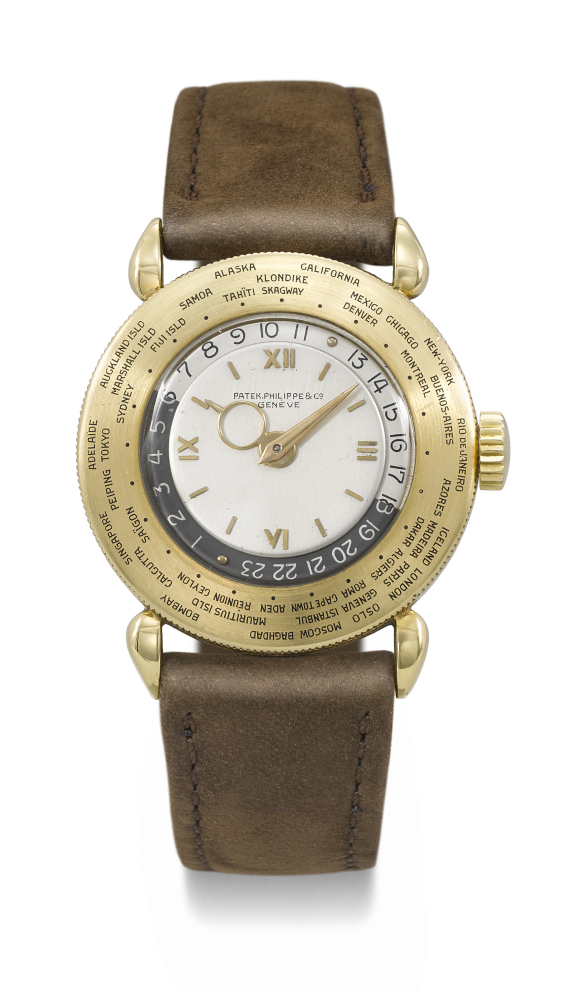 PATEK PHILIPPE. A VERY RARE AND ATTRACTIVE 18K GOLD WORLD TIME WRISTWATCH