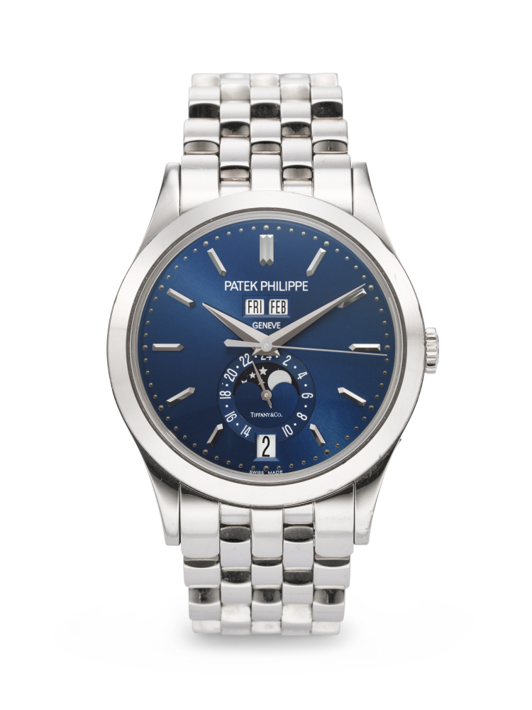 PATEK PHILIPPE. A VERY RARE AND ELEGANT 18K WHITE GOLD AUTOMATIC ANNUAL CALENDAR WRISTWATCH WITH SWEEP CENTER SECONDS, MOON PHASES, 24-HOUR INDICATION, AND BRACELET