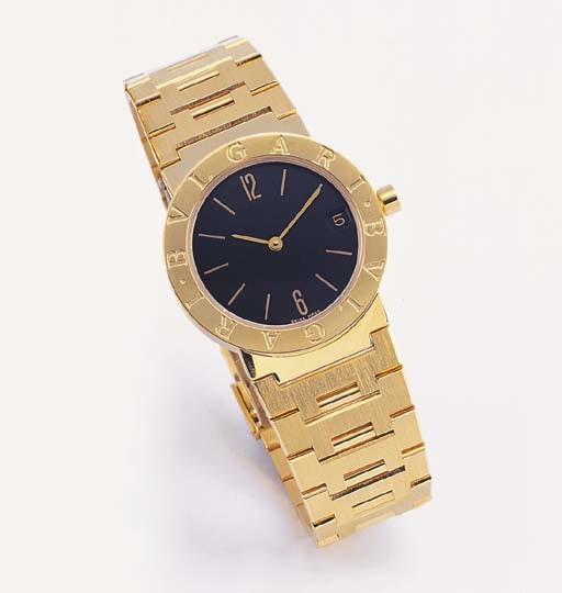 BULGARI. AN 18K GOLD WRISTWATCH WITH DATE AND BRACELET