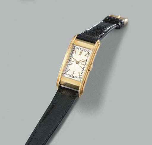 Patek Philippe. A fine and rare 18K gold rectangular curved hinged wristwatch
