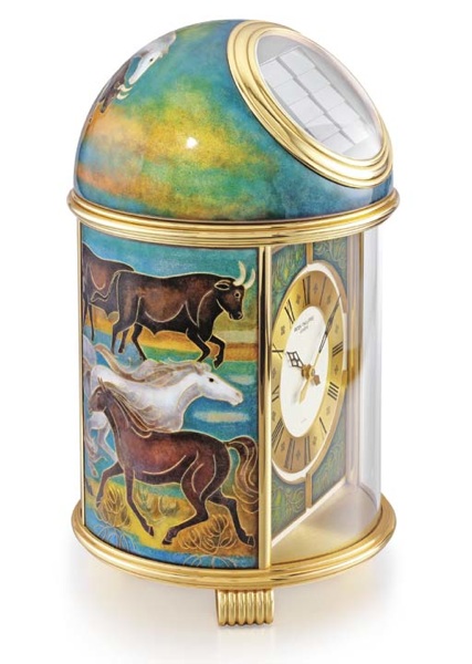Patek Philippe. A fine and unique gilt brass and enamel solar-powered table clock