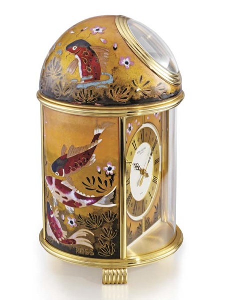 Patek Philippe. A fine and unique gilt brass and enamel solar-powered table clock
