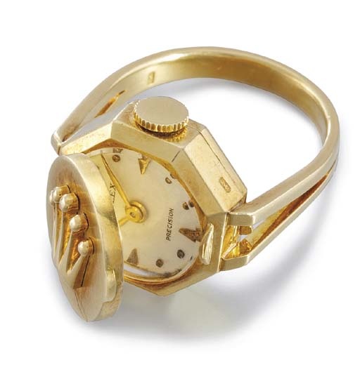 Rolex. An 18K gold ring watch with concealed dial
