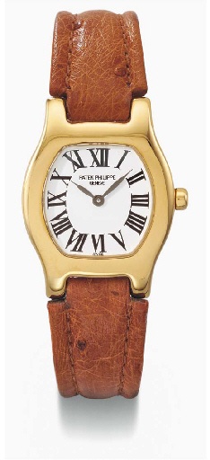 Patek Philippe. A ladies 18K gold tonneau-shaped wristwatch