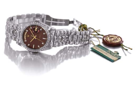 Rolex. An impressive 18K white gold and diamond-set self-winding water-resistant calendar wristwatch with sweep centre seconds, bracelet and burgundy dial