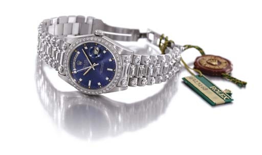 Rolex. A fine and unusual 18K white gold and diamond-set self-winding water-resistant calendar wristwatch with sweep centre seconds and bracelet