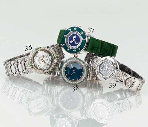 GERALD GENTA. A LADY'S 18K WHITE GOLD, DIAMOND AND TOPAZ BRACELET WATCH