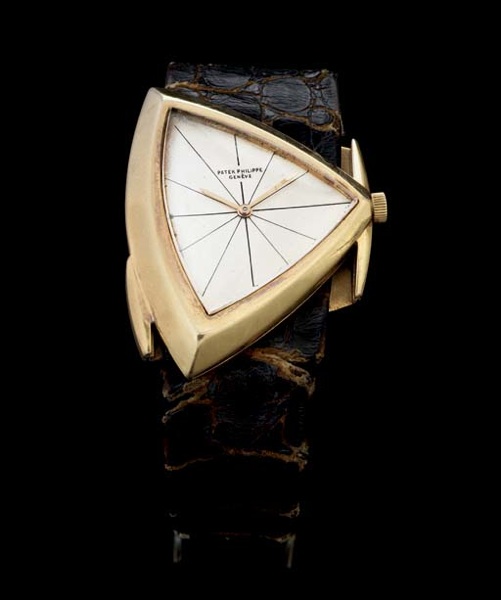 PATEK PHILIPPE. A RARE AND UNUSUAL 18K GOLD AYSMMETRICAL WRISTWATCH