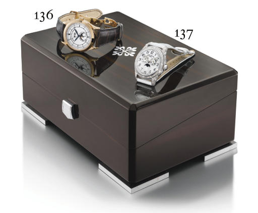 Patek Philippe. A fine and rare 18K white gold and diamond-set self-winding annual calendar wristwatch with sweep centre seconds and mother-of-pearl dial