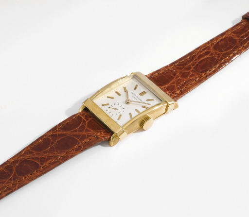 Patek Philippe. A fine 18K gold rectangular curved wristwatch