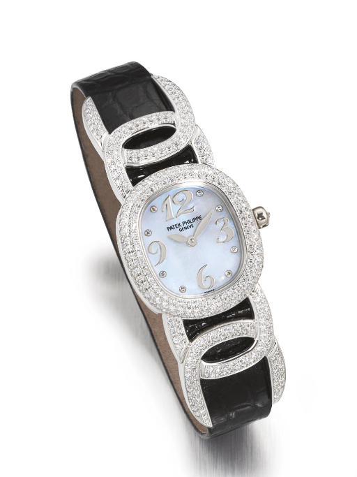 PATEK PHILIPPE. A FINE LADY'S 18K WHITE GOLD AND DIAMOND-SET WRISTWATCH WITH MOTHER-OF-PEARL DIAL
