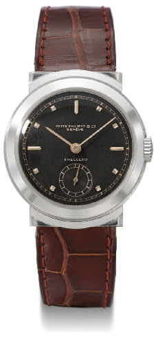 Patek Philippe. A rare and unusual stainless steel wristwatch with black dial and hooded lugs
