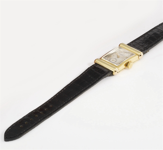 Patek Philippe. An unusual 18K pink and yellow gold rectangular curved wristwatch with cylindrical hooded lugs