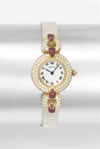 Cartier. A lady's fine 18K gold, diamond and ruby-set wristwatch
