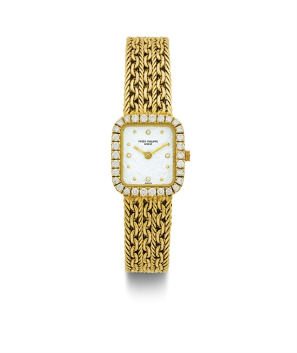 PATEK PHILIPPE. A LADY'S 18K GOLD AND DIAMOND BRACELET WATCH