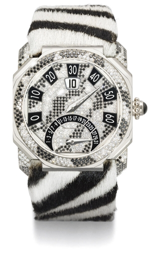 Gerald Genta. A large and unusual 18K white gold and diamond-set gold octagonal automatic jump hour retrograde wristwatch with retrograde date and zebra-design bracelet