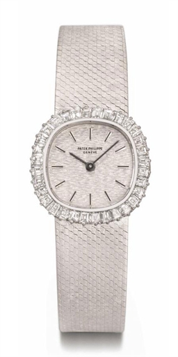 Patek Philippe. A lady's fine and attractive 18K white gold and diamond-set cushion-shaped wristwatch with bracelet and original certificate