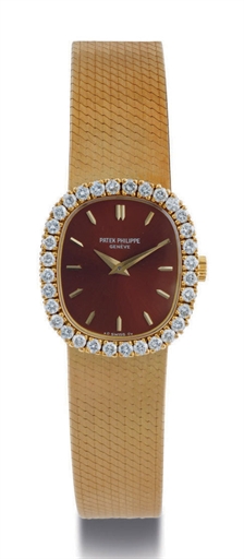 PATEK PHILIPPE. A LADY'S 18K GOLD AND DIAMOND CUSHION BRACELET WATCH
