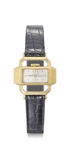 Rolex. An unusual and rare 18K gold rectangular driver's wristwatch