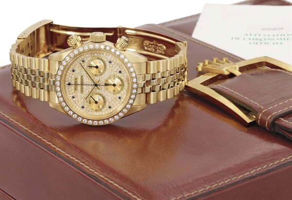 Rolex. An extremely rare and attractive 18K gold, diamond and sapphire-set chronograph wristwatch with bracelet