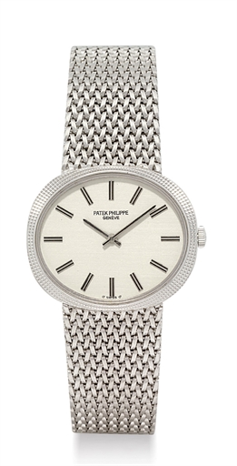 PATEK PHILIPPE. AN 18K WHITE GOLD OVAL WRISTWATCH WITH BRACELET