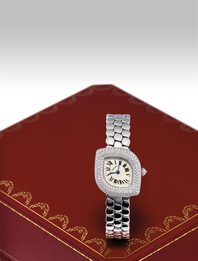 CARTIER. A LADY'S 18K WHITE GOLD AND DIAMOND-SET NAVETTE-SHAPED WRISTWATCH WITH BRACELET