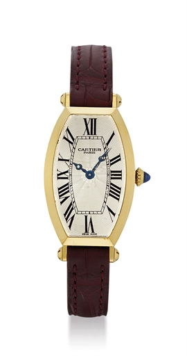 CARTIER. A LADY'S 18K GOLD TONNEAU-SHAPED CURVED WRISTWATCH