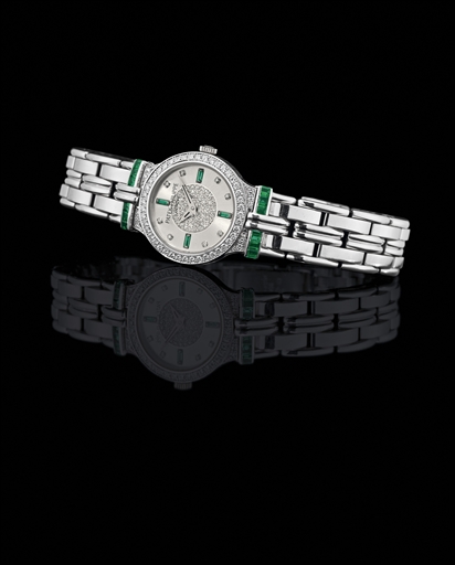 PATEK PHILIPPE. A LADY'S FINE 18K WHITE GOLD, DIAMOND AND EMERALD-SET WRISTWATCH WITH BRACELET